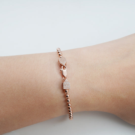 Rosékleurige ronde armband bezet met briljanten
